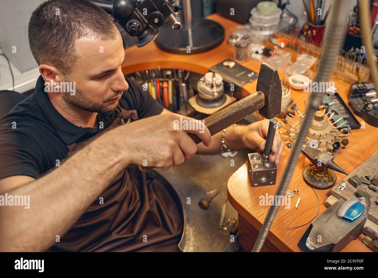 Serious young man using a metal working tool Stock Photo