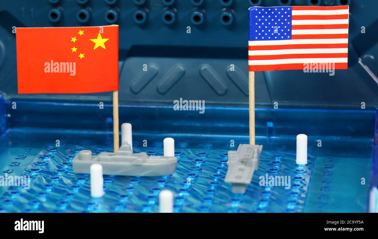American, U.S, USA United States of American Naval Navy warship meet Chinese navy ship on a Battleship Board game. National flags. Disputed South Chin Stock Photo