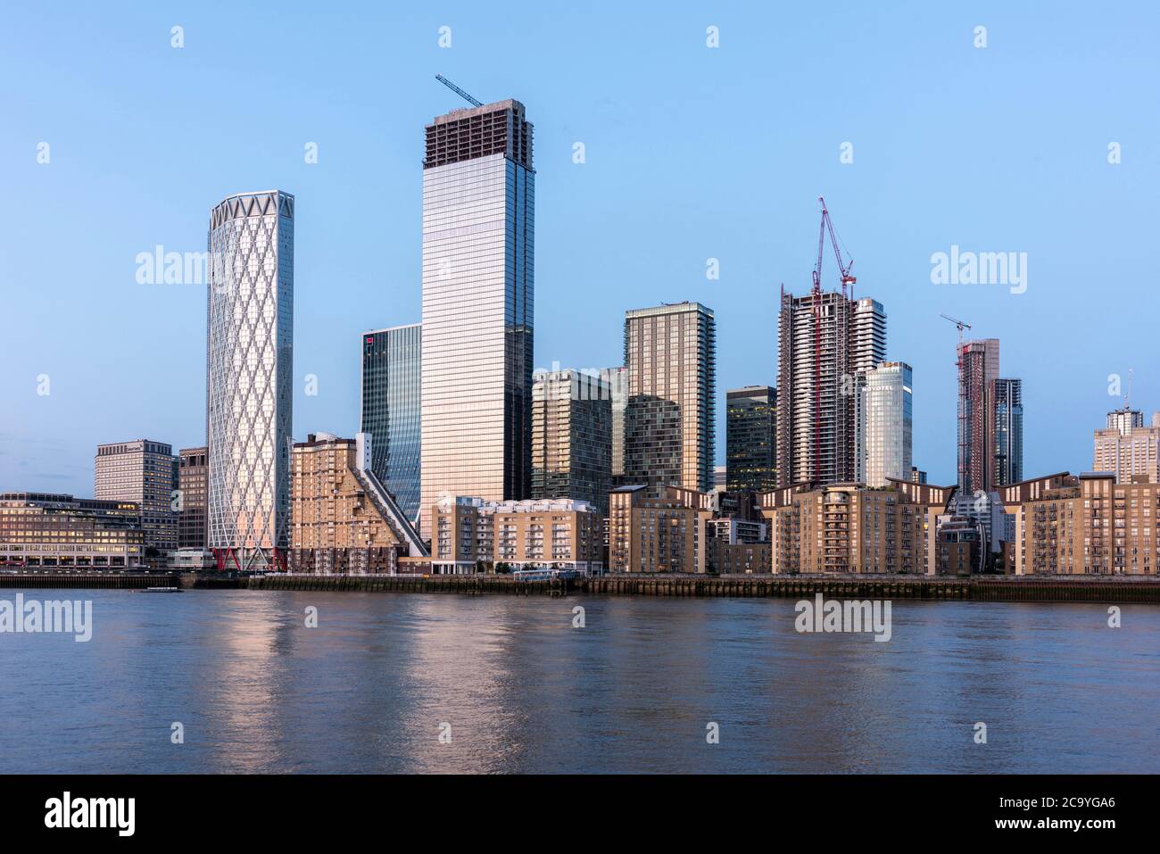 View across Thames from west at sunset. Isle of Dogs, London, United Kingdom. Architect: Various, 2020. Stock Photo