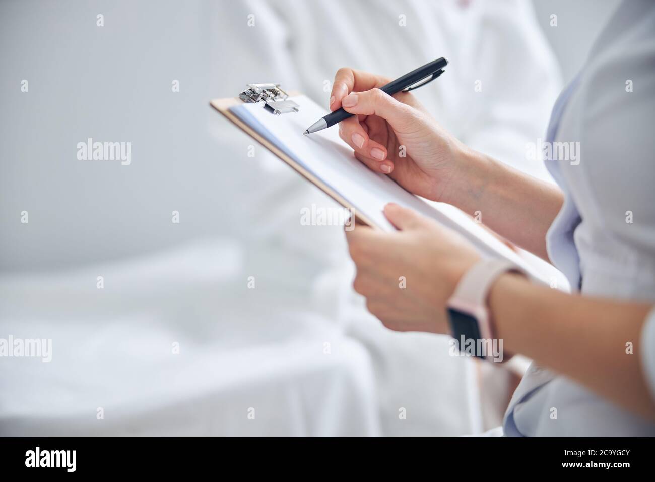 Beautiful female arms writing something on paper Stock Photo Alamy
