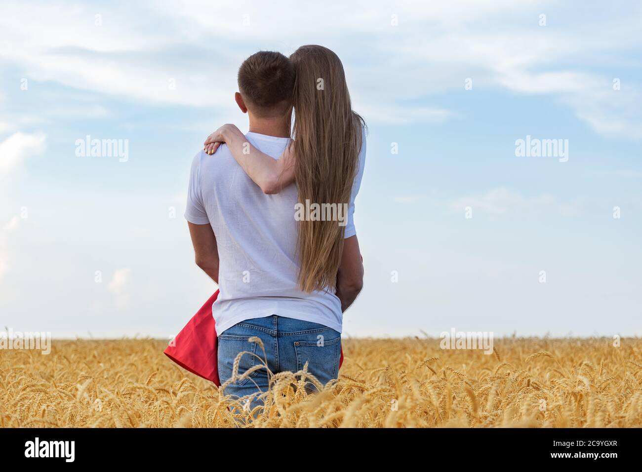 Man gently holding his beloved in wheat field. Romantic time outsides ...