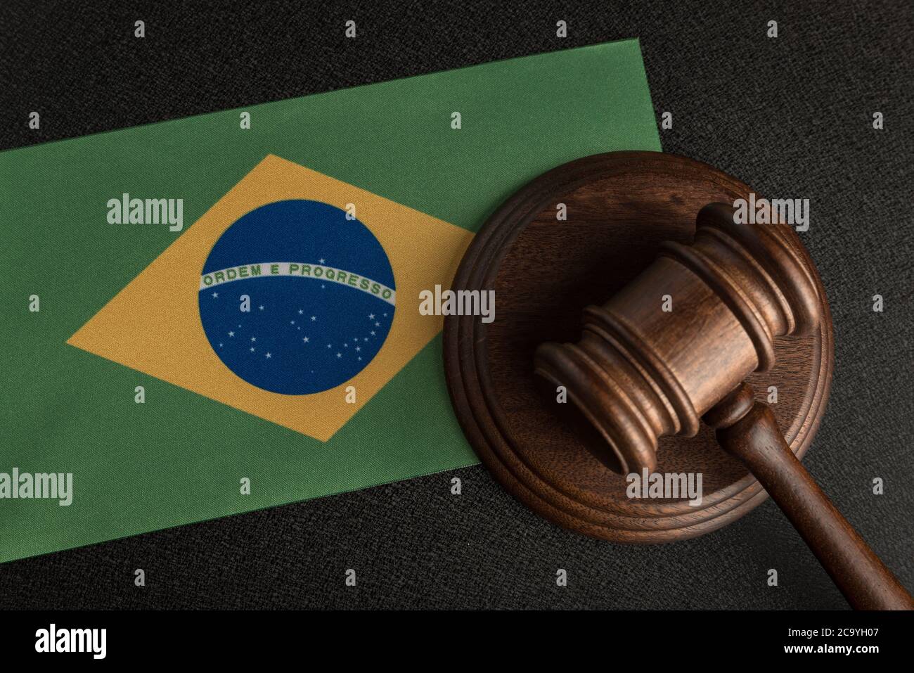 Judge or auction gavel on background of flag of Brazil. Constitutional