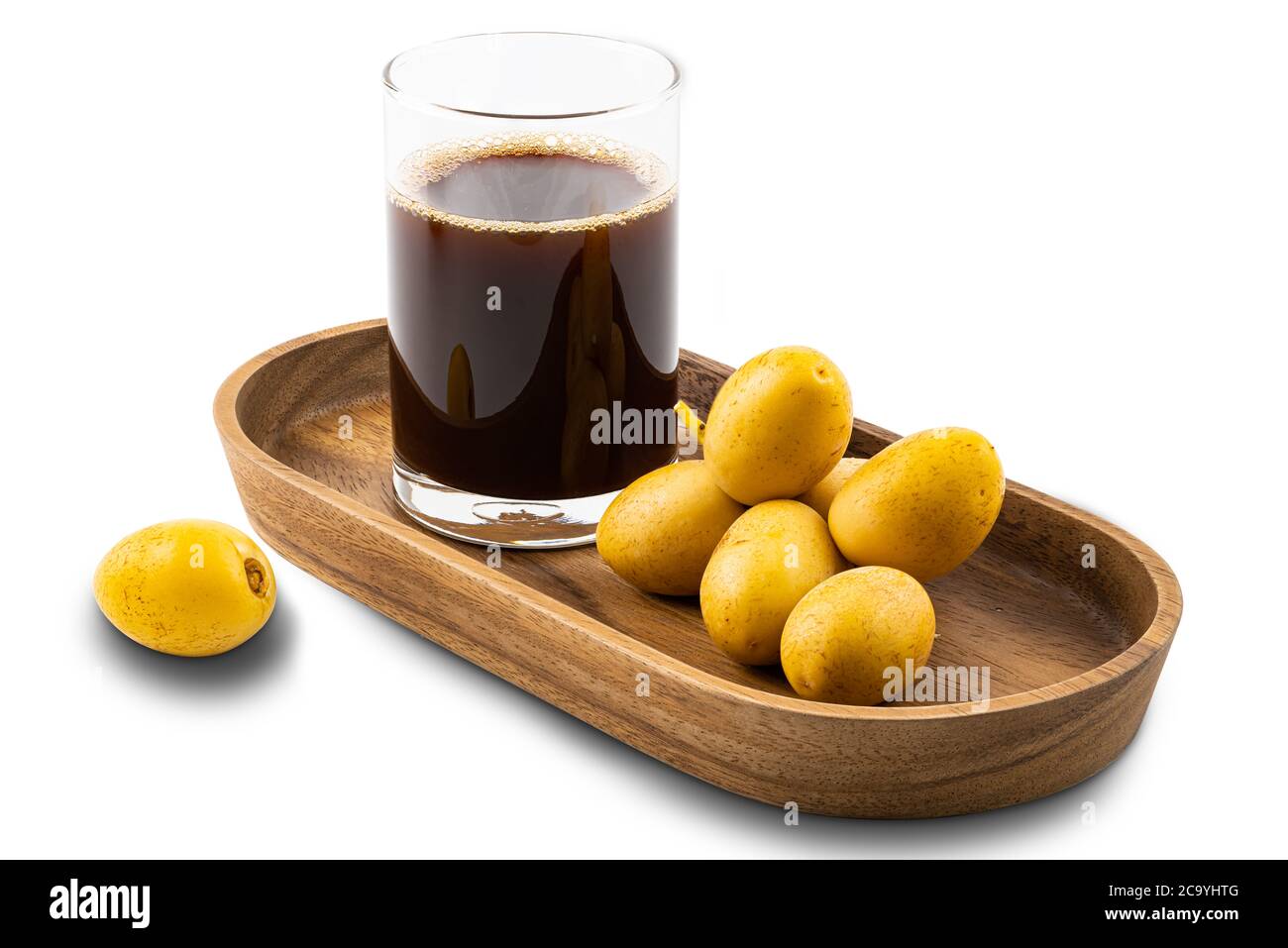 Homemade date juice in a glass and a bunch of fresh ripe date in a wooden tray on white background with clipping path. Stock Photo