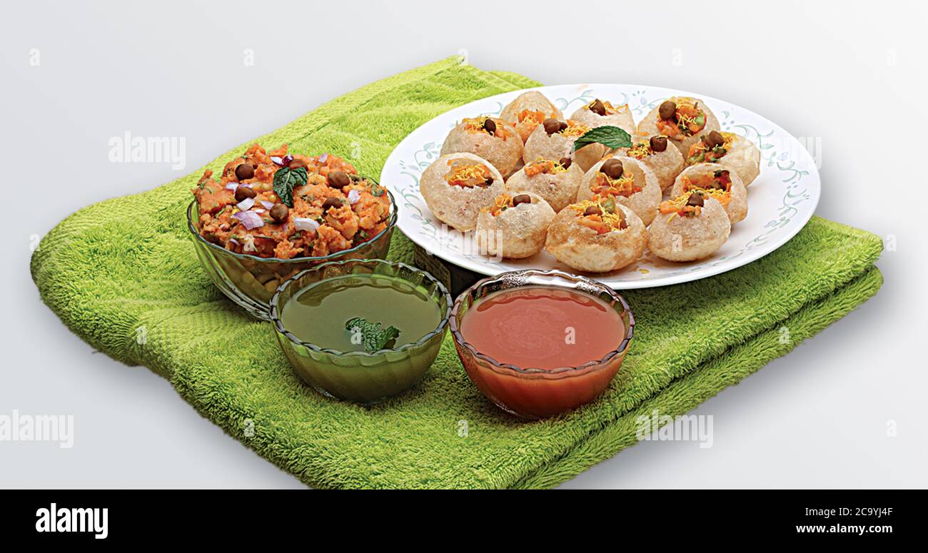 Panipuri or Golgappa is a common street snack from India. It's a round, hollow puri filled with a mixture of flavoured water and other chat items. Stock Photo