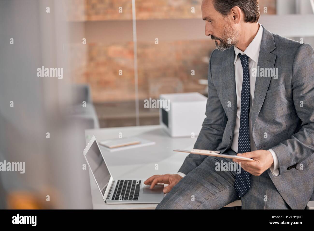 Handsome bearded man using notebook at work Stock Photo