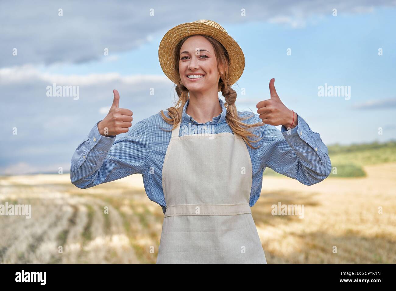 Woman farmer straw hat apron standing farmland smiling showing thumb up ...