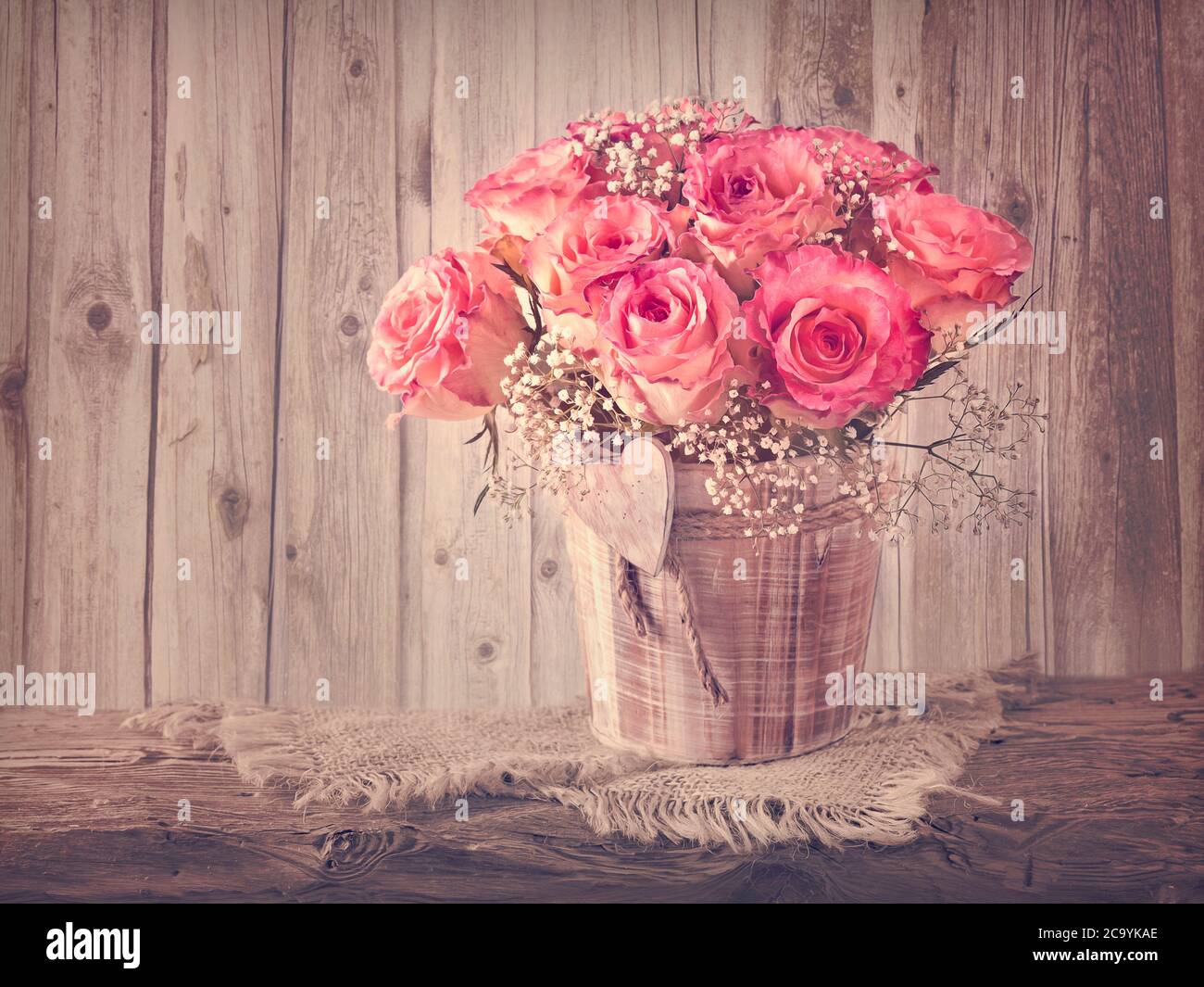 Pink roses on wooden desk Stock Photo Alamy