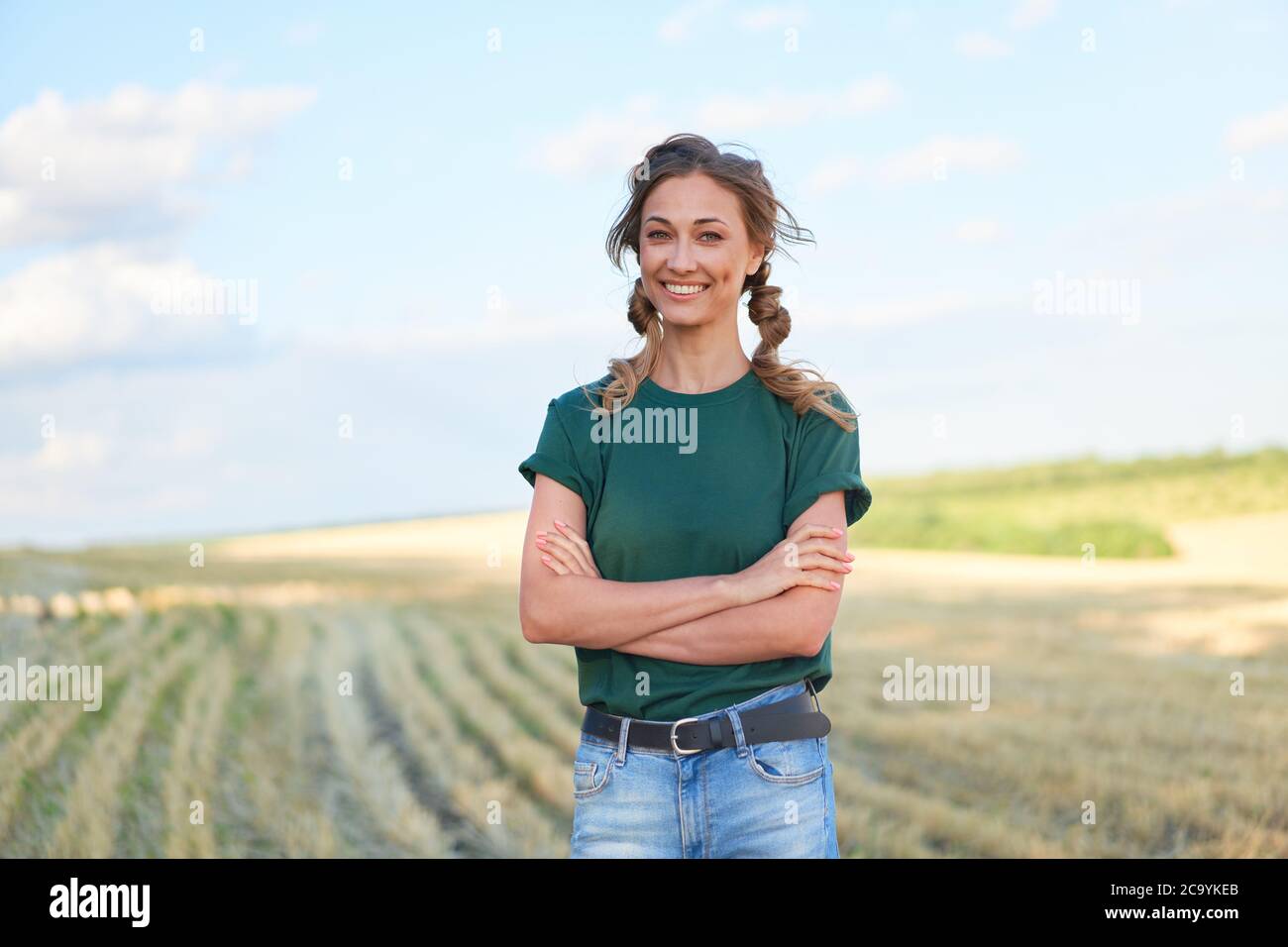 Woman farmer straw hat standing farmland smiling Female agronomist specialist farming agribusiness Happy positive caucasian worker agricultural field Stock Photo