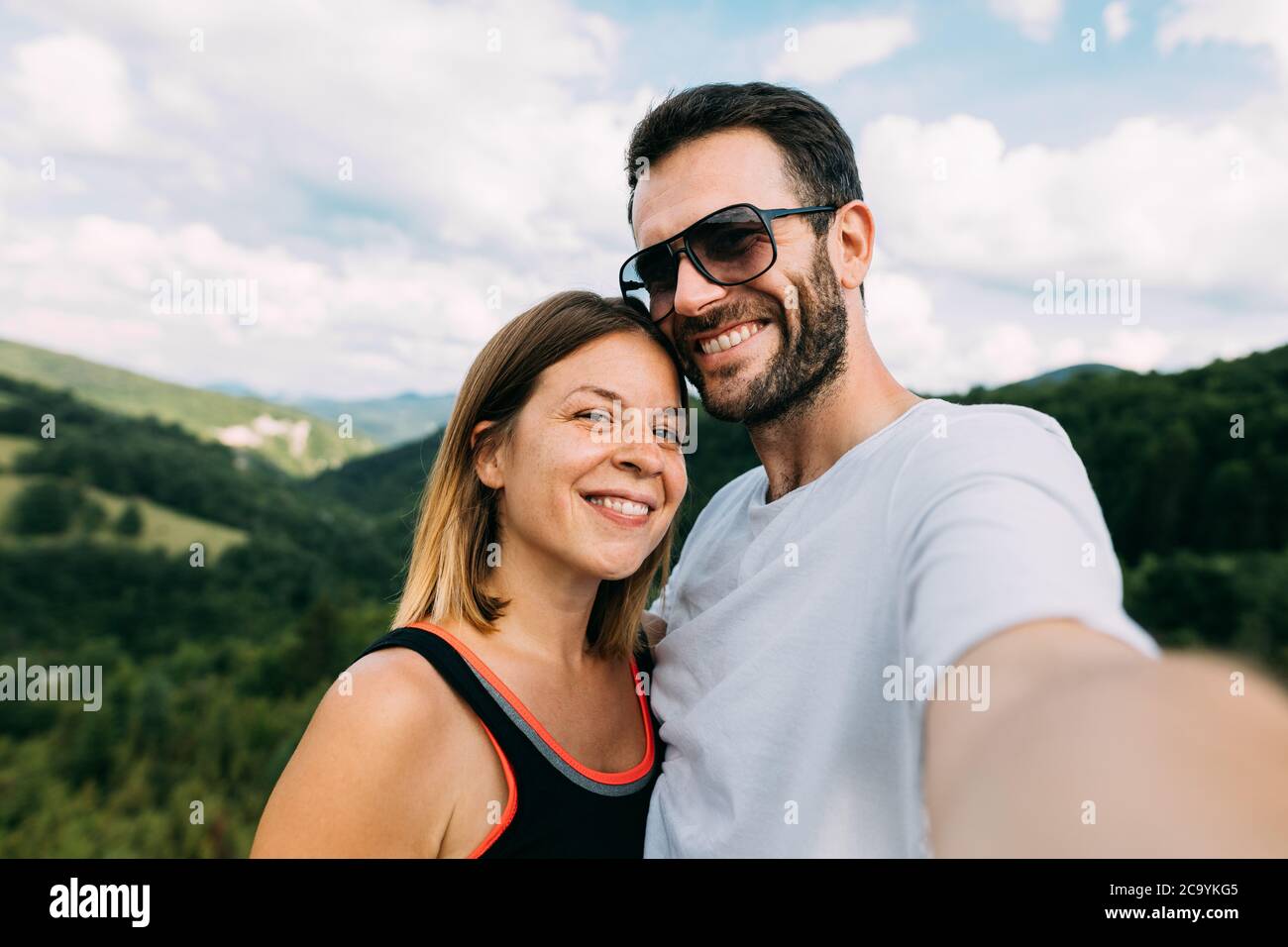 Young couple taking a selfie in the mountains Stock Photo