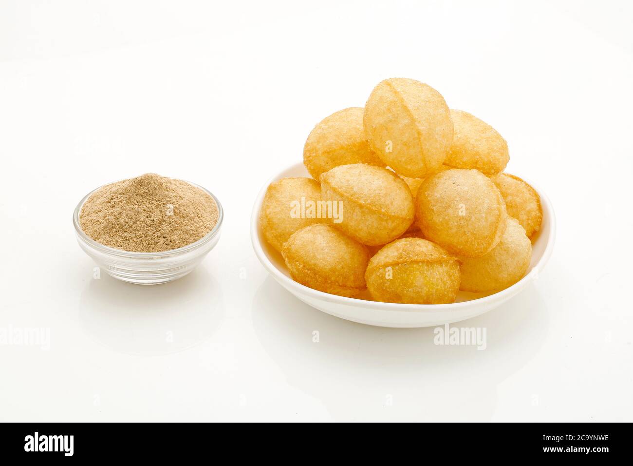Panipuri or Golgappa is a common street snack from India. It's a round, hollow puri filled with a mixture of flavoured water and other chat items. Stock Photo