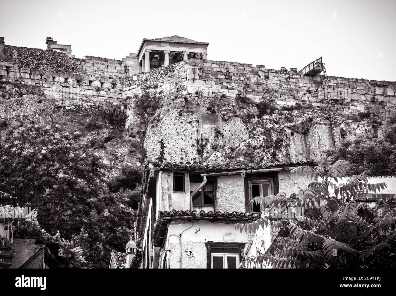 Acropolis of Athens and old houses in Plaka district, Greece. Famous hill with classical Greek ruins is top landmark of Athens. Vintage view of ancien Stock Photo