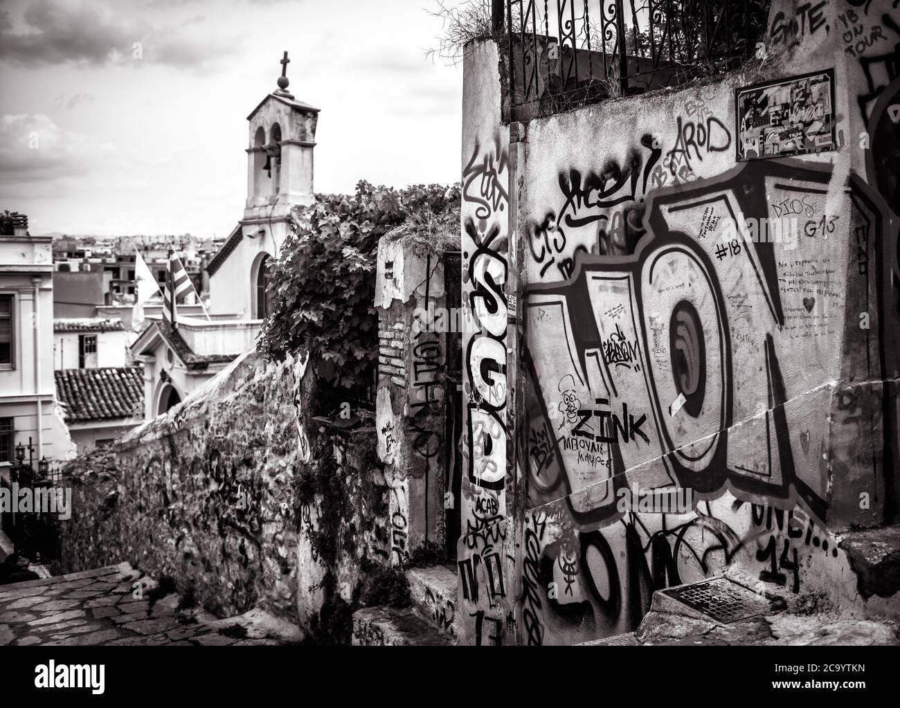Athens - May 6, 2018: Old street with graffiti in Plaka district, Athens, Greece. Plaka is one of main tourist attractions of Athens. Traditional vint Stock Photo