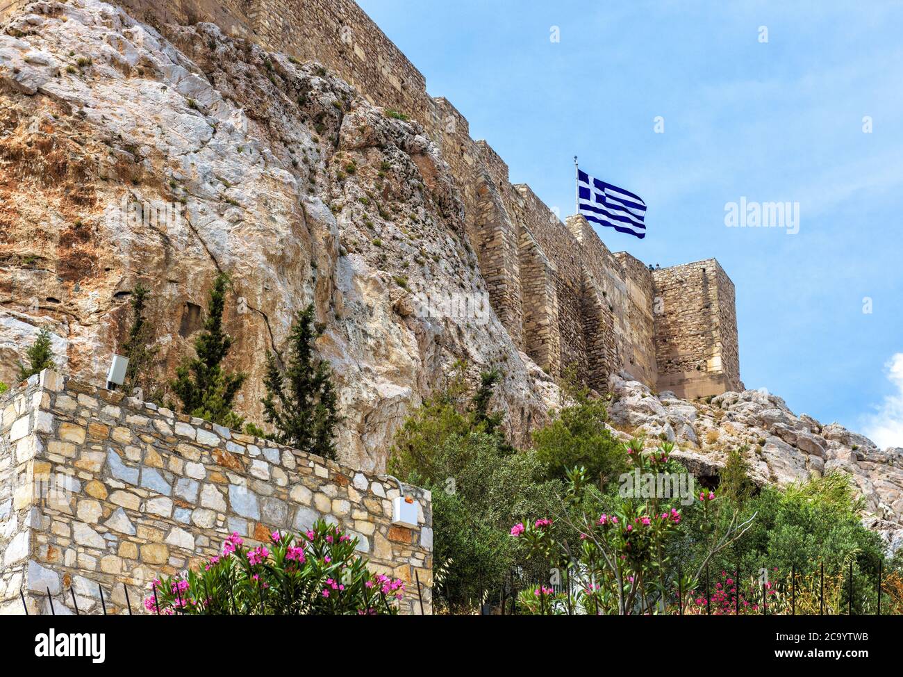 Acropolis with strong medieval fortress walls, Athens, Greece. Famous Acropolis hill is top landmark of Athens city. Scenic view of old castle and Anc Stock Photo