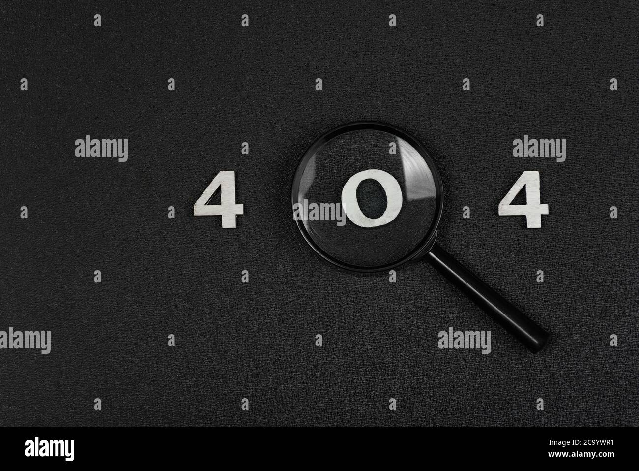 numerals 404 and magnifying glass on black background. Error concept. Stock Photo