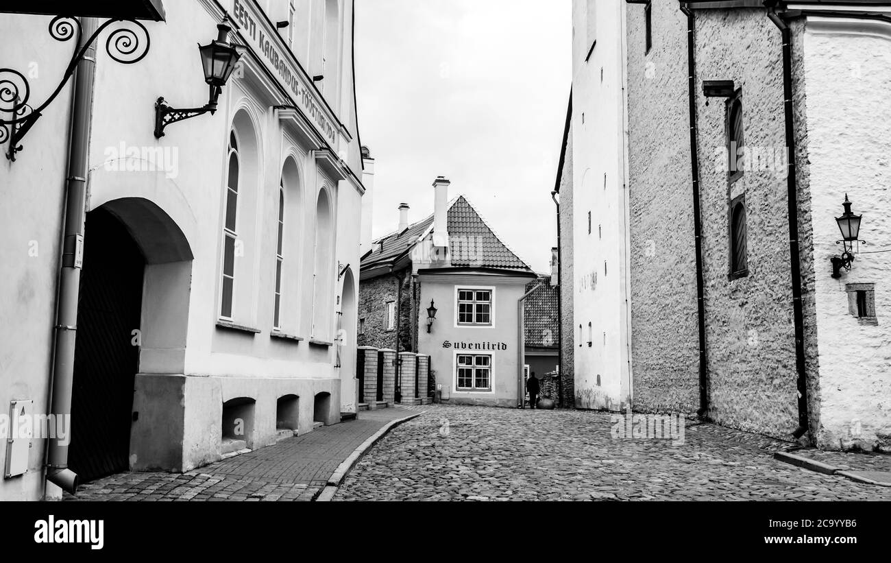 Tallinn, Estonia - May 26, 2019: Man walking down the street in Old town in Tallinn, black and white image Stock Photo