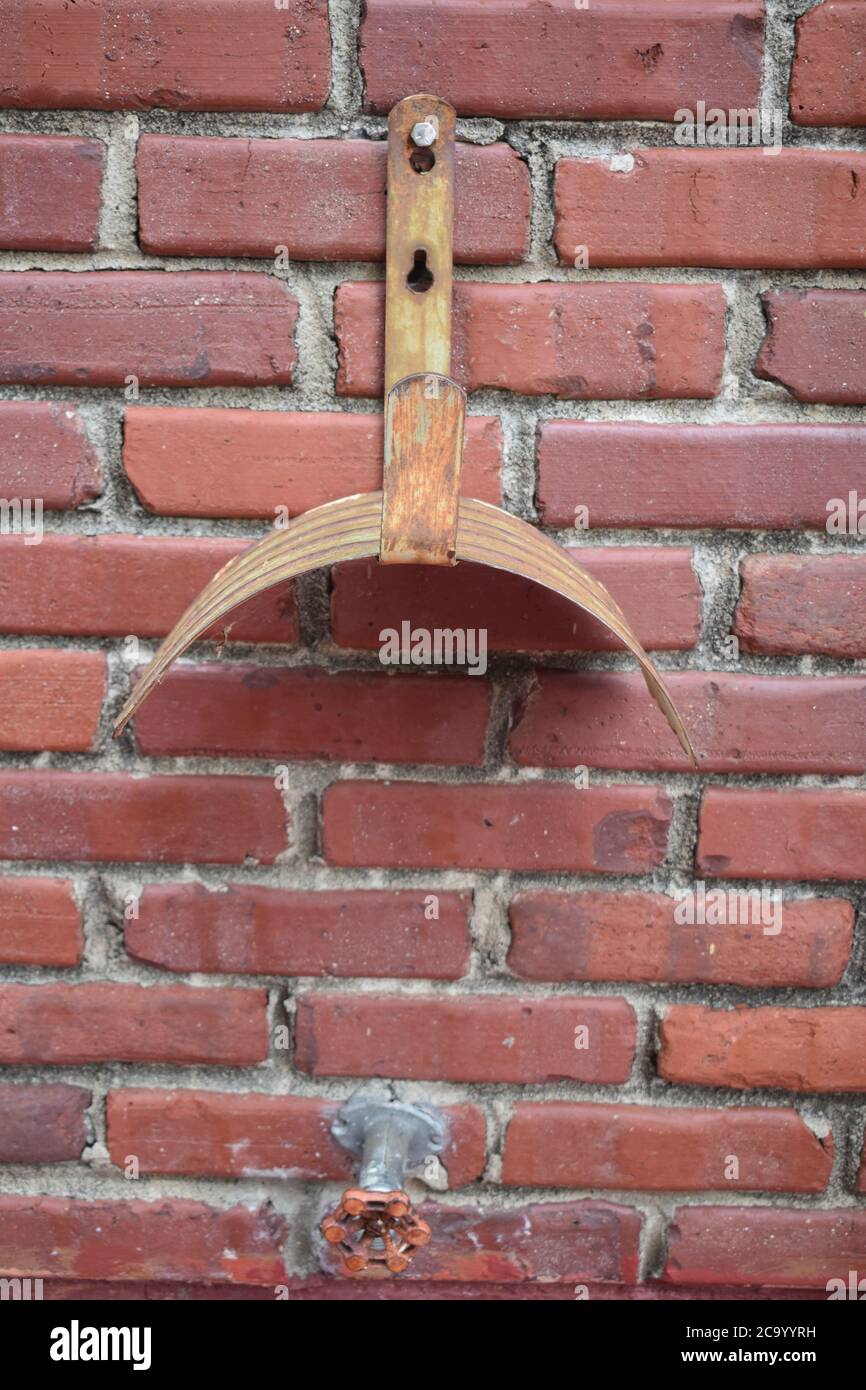Garden Hose Holder and Faucet on a Brick Wall Stock Photo Alamy