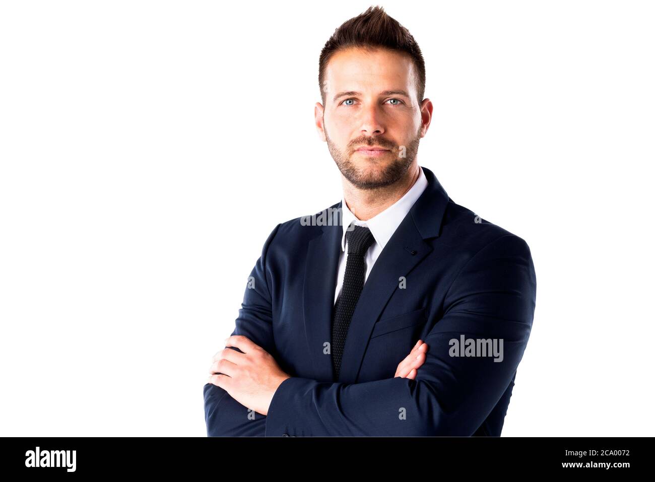 Studio portrait of confident businessman wearing suit while standing at ...