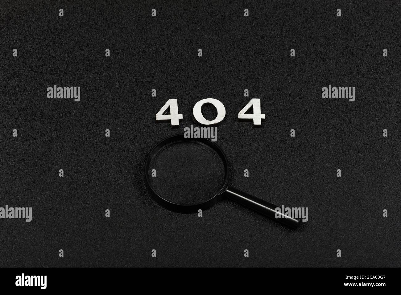 Numerals 404 and magnifying glass on black background. Error concept Stock Photo
