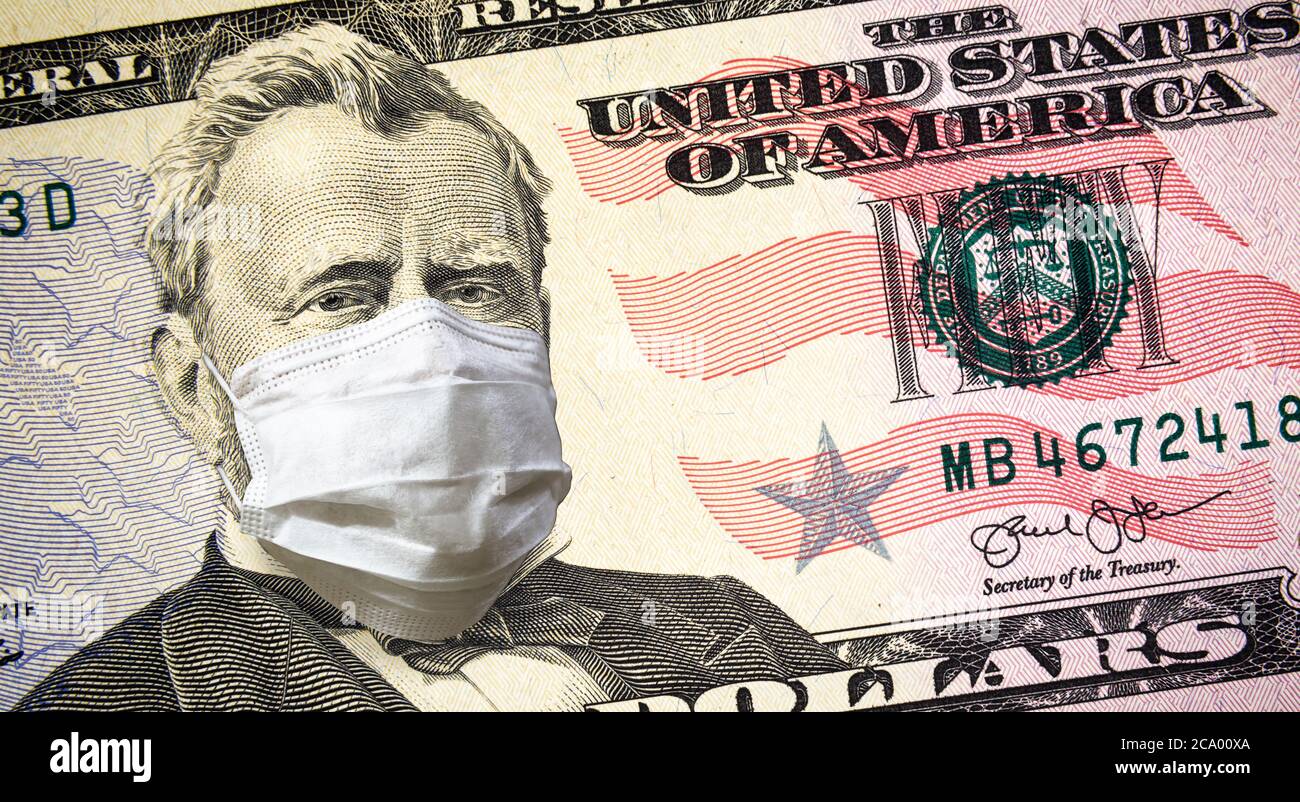 COVID-19 in USA, President with face mask on 50 dollar money note. Coronavirus affects global stock market, world economy hit by corona virus pandemic Stock Photo