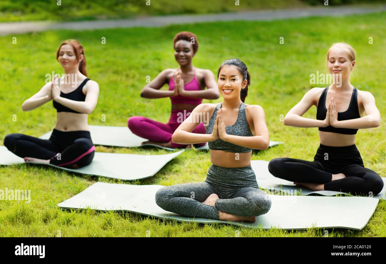 Wellness concept. Tranquil young women deep in meditation during their