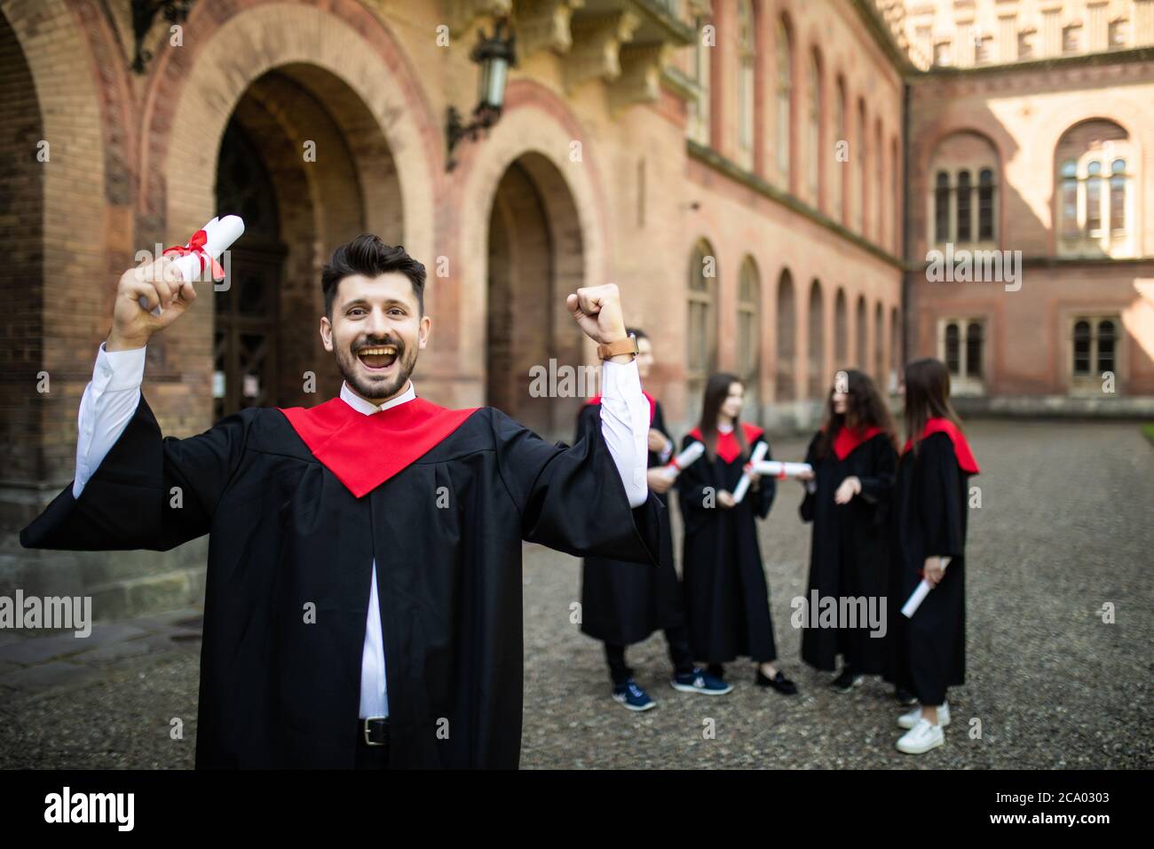 graduation man in front of a group of graduation students Stock Photo ...
