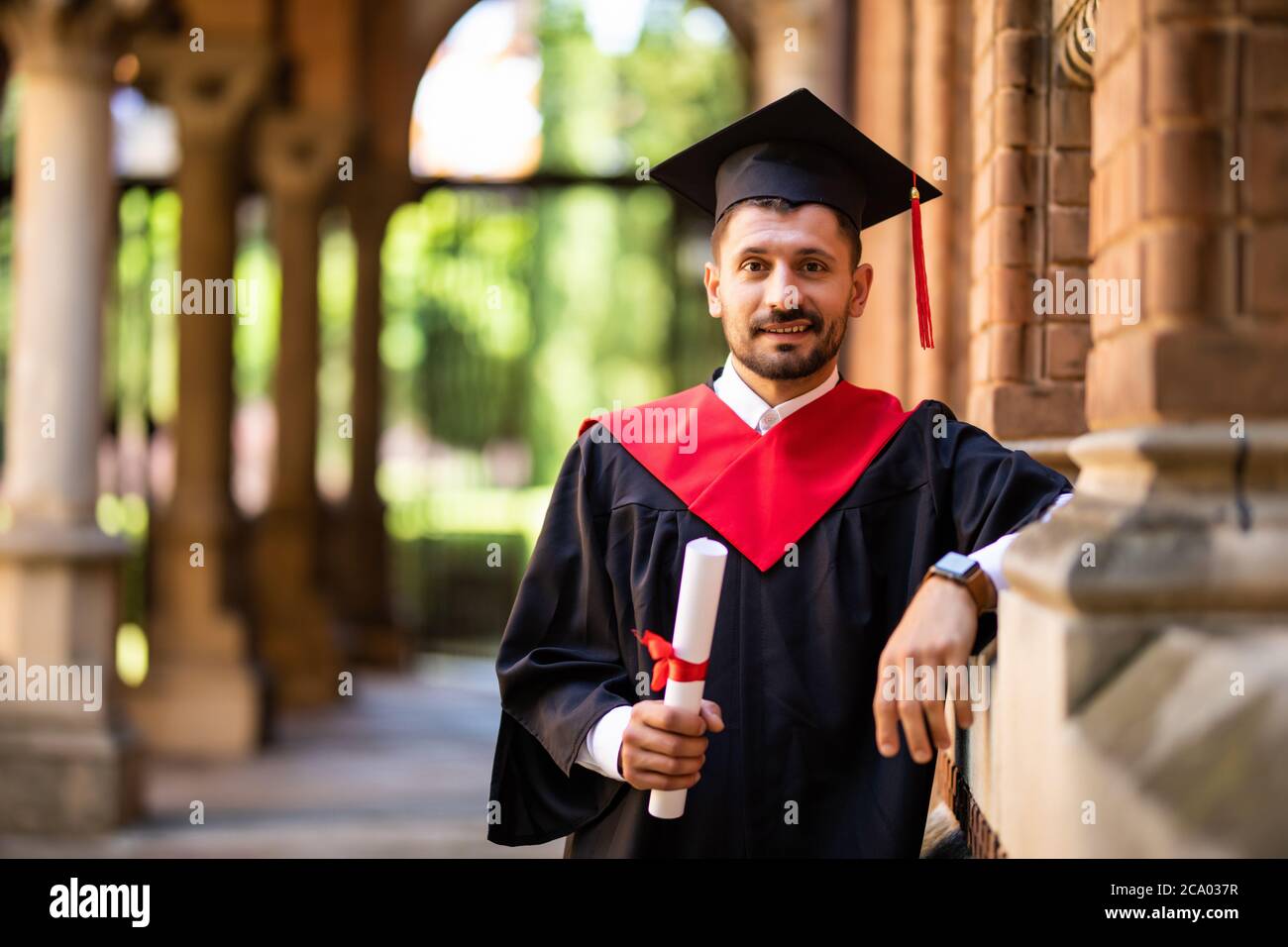 Graduate man student. Graduation concepts. Portrait of young man on graduation day at University. Education, people concept. Stock Photo