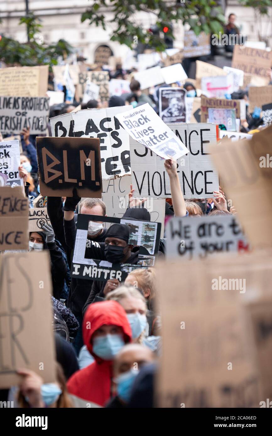 Huge crowds of people gather and displays signs and banners at the black lives matter uk protest march in London, England UK Stock Photo