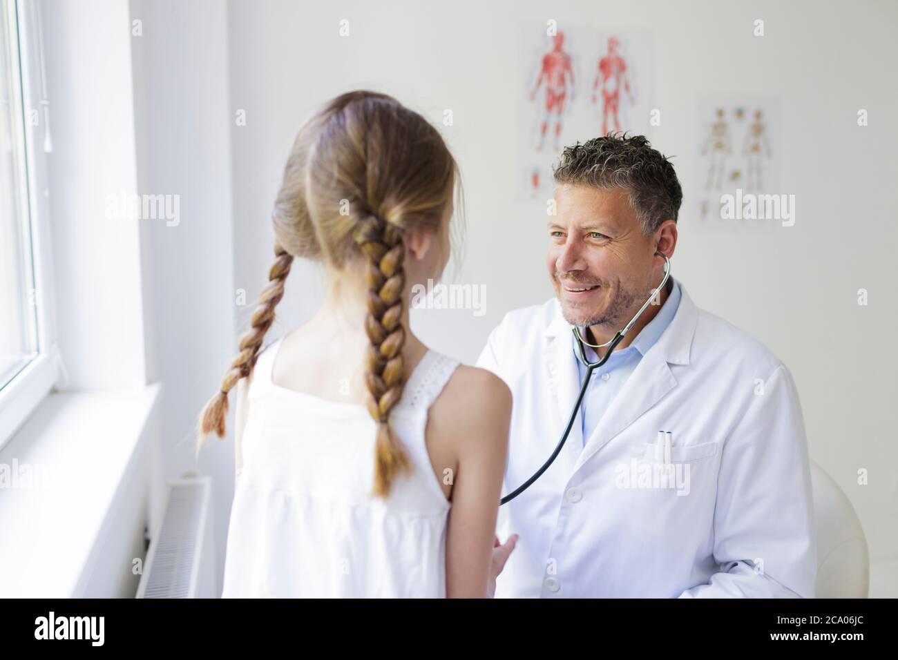 Female doctor examines male patient with hair loss problem at consultation  in clinic Stock Photo - Alamy