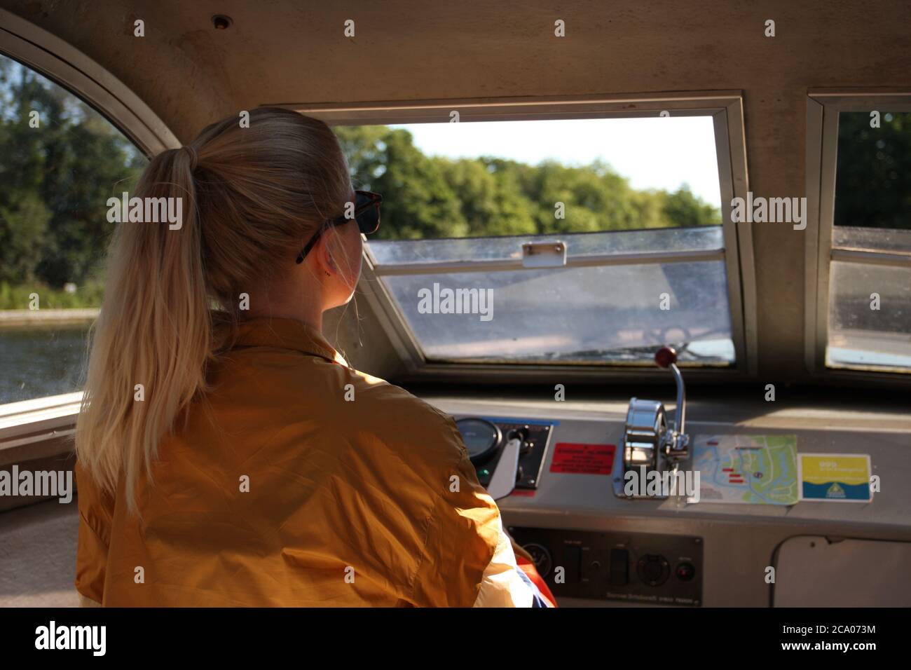 Woman steering boat hi-res stock photography and images - Alamy