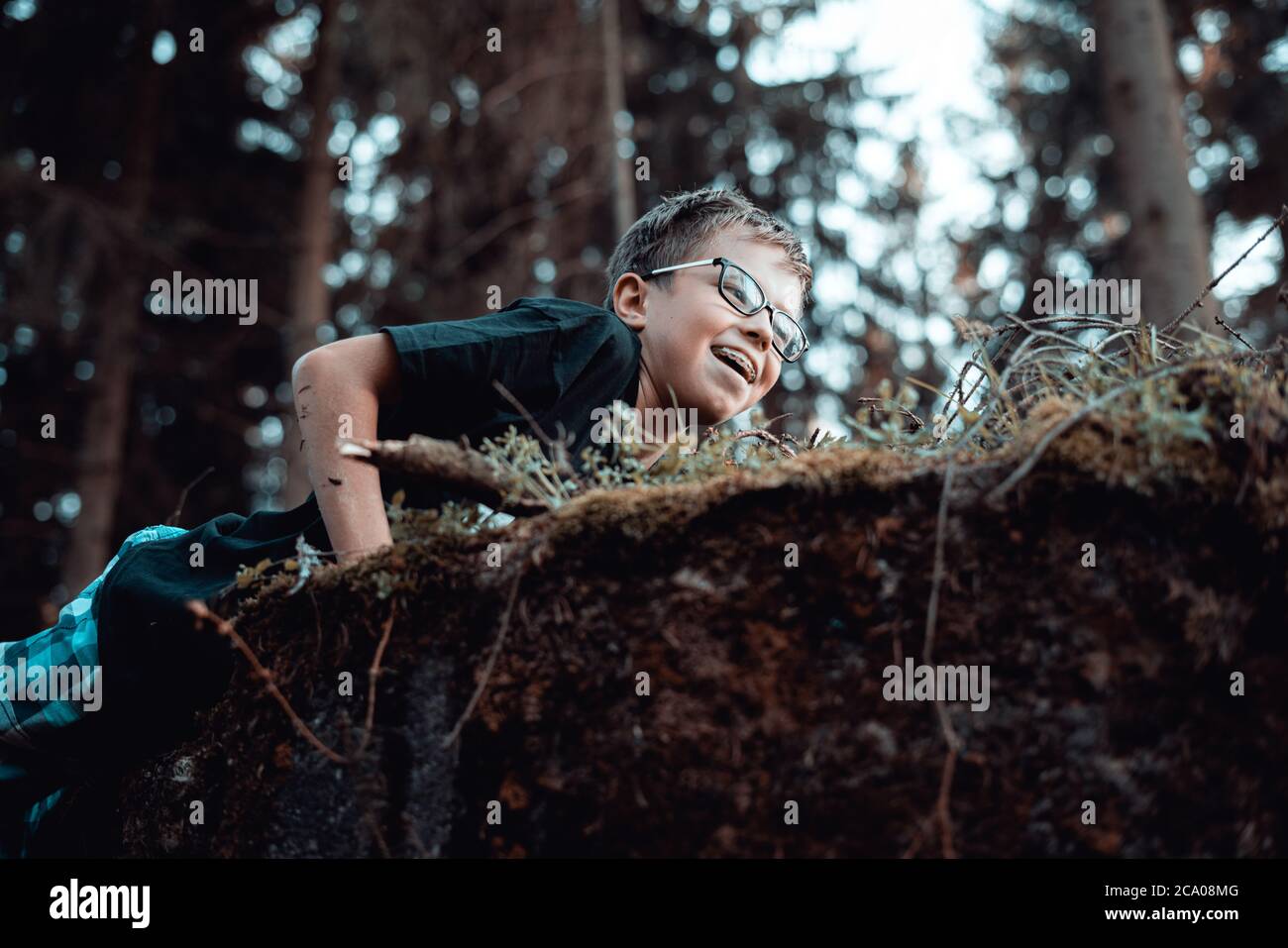 of happy Young teenager boy playing In the forest Stock Photo