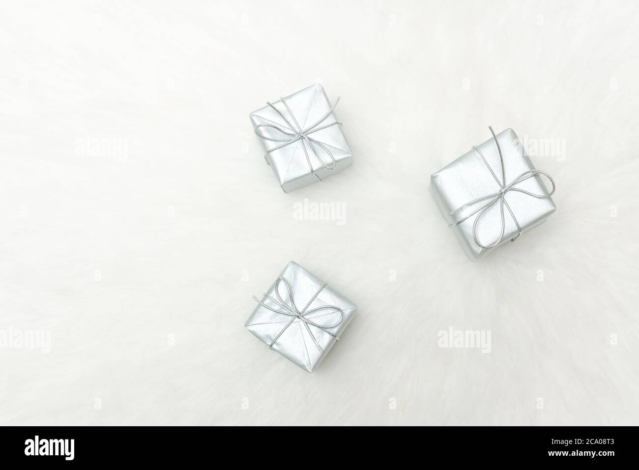Three silver gift boxes on a white background. Holiday concept Stock Photo