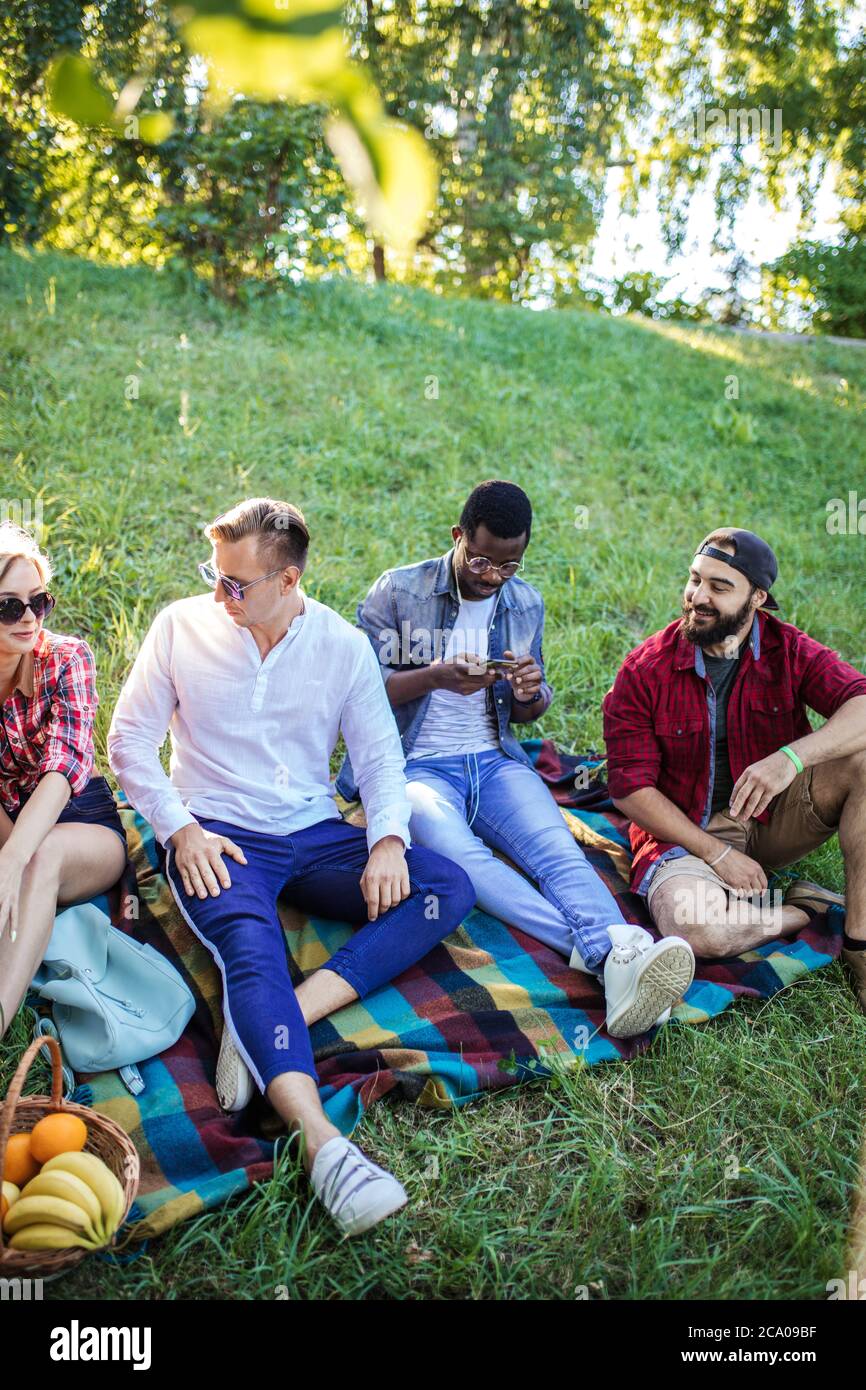 Group of multiracial friends dressed in casual summer clothing with smartphone having fun together at park, watching funny video in social media Stock Photo - Alamy Group of multiracial friends dressed in casual summer clothing with smartphone having fun together at park, watching funny video in social media Stock Photo - Alamy