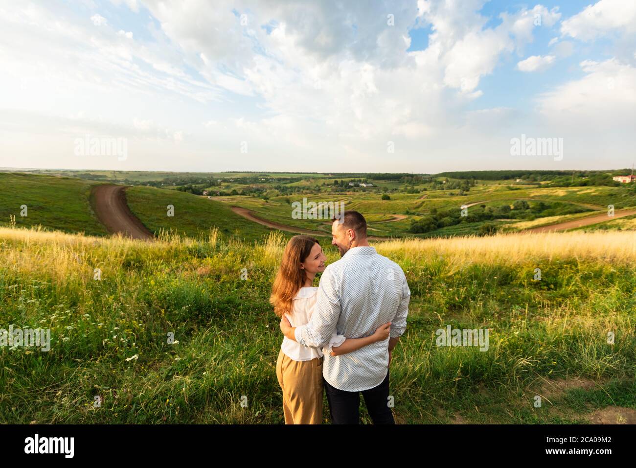 Young couple enjoying landscape outdoors, rear view Stock Photo - Alamy