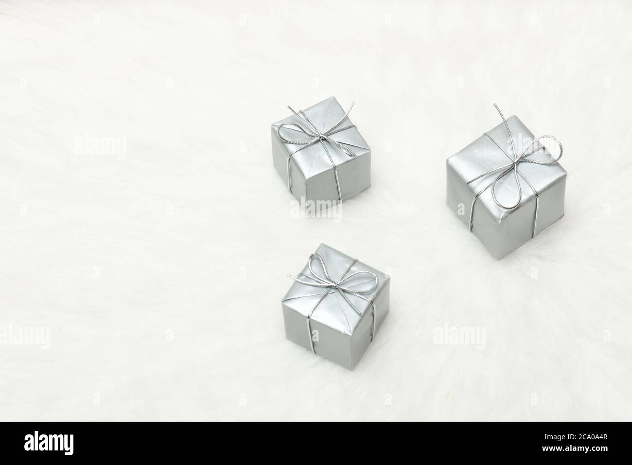 Three silver gift boxes on a white background. Holiday concept Stock Photo