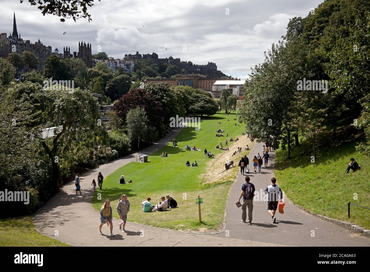 Edinburgh, Scotland, UK. 3 August 2020. Looking a wee bit more normal on the cities streets with some tourists wandering the pavements looking at landmarks and visitingPrinces Street Gardens. Concerns are growing over the potential of widespread job losses in Edinburgh tourism industry  two-thirds of the city’s hotels rooms may be left lying empty this month.No festivals, a slump in overseas visitors, the closure of attractions and a reluctance by UK holidaymakers to book city breaks perhaps “the worst month ever for tourism. Credit: Arch White/ Alamy Live News. Stock Photo