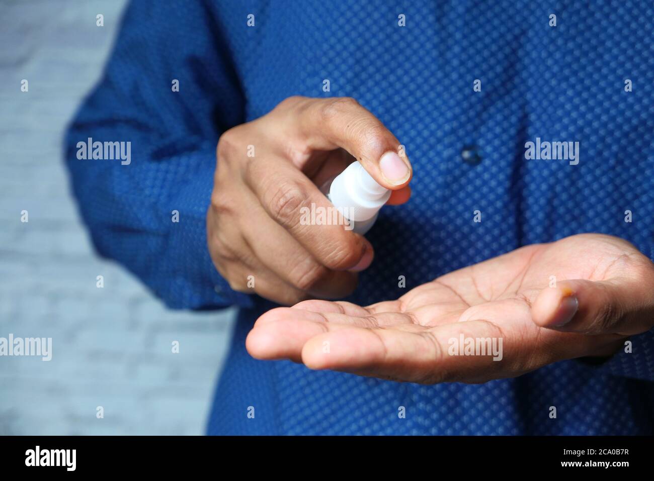 close up of young man hand using hand sanitizer spray Stock Photo Alamy