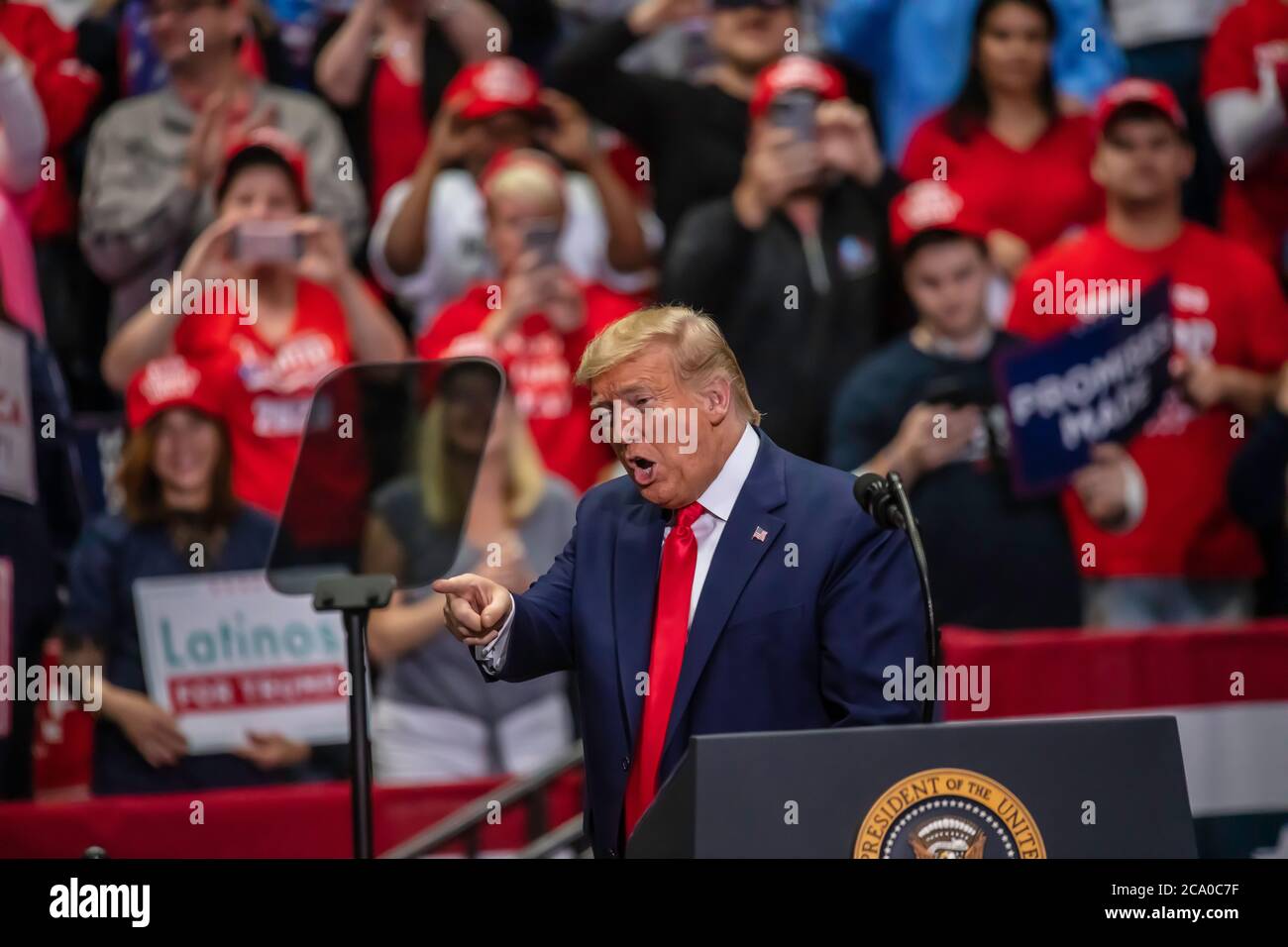 President Trump  acknowledges supporters in the crowd at the rally in the Bojangle's Coliseum Stock Photo
