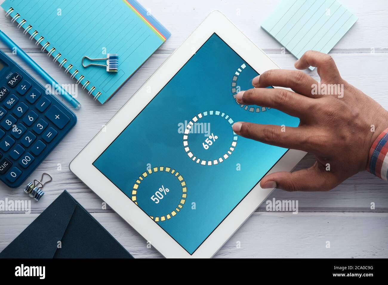 man's hand working on digital tablet at office desk, using self created ...