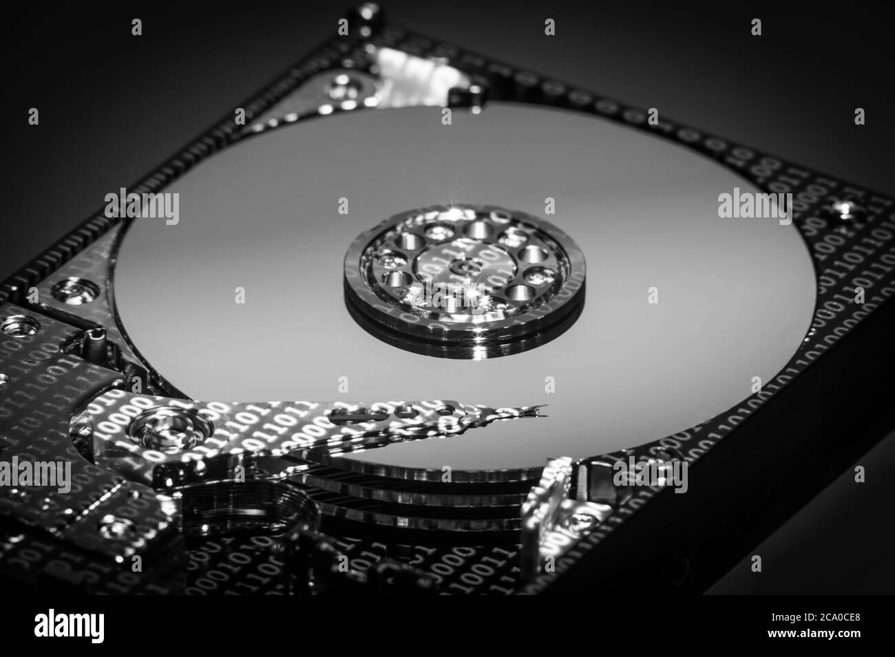 A hard disk drive (HDD)  with data projected on it. Stock Photo