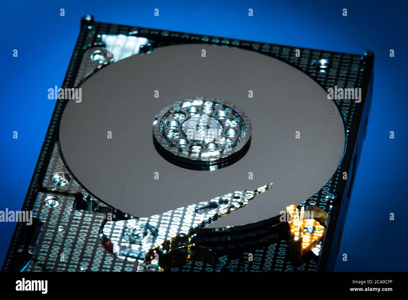 A hard disk drive (HDD) with data projected on it. Stock Photo