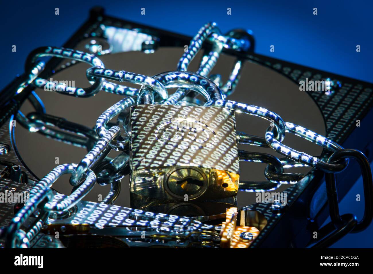 A hard disk drive (HDD) in padlocked chains with data projected on it. Stock Photo