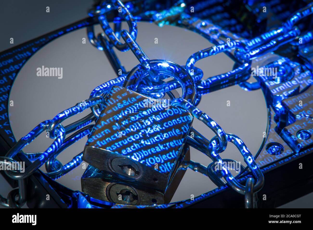 A hard disk drive (HDD) in padlocked chains with data projected on it. Stock Photo