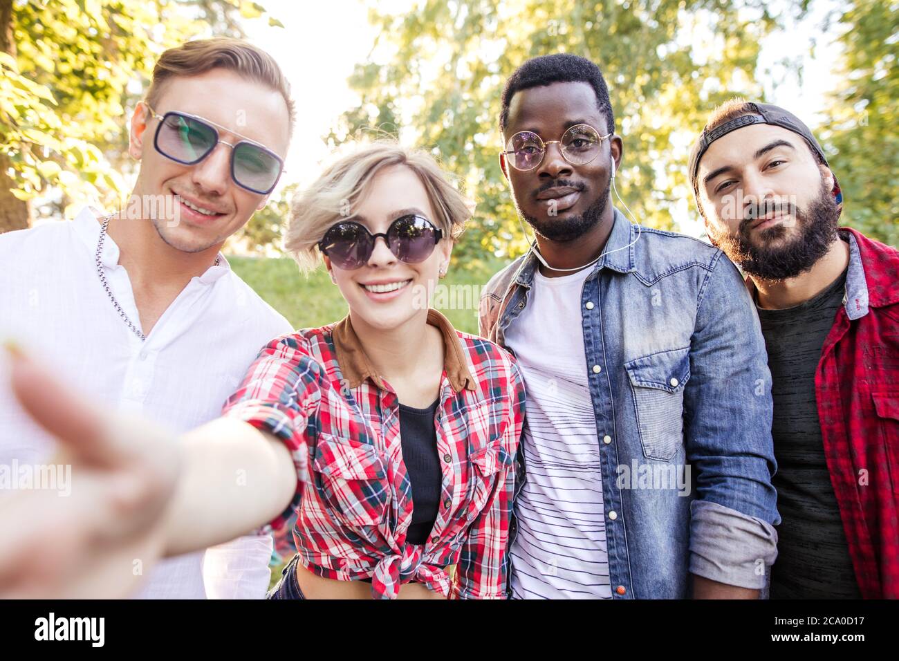 Group of multiracial friends dressed in casual summer clothing with  smartphone having fun together at park, watching funny video in social  media Stock Photo - Alamy