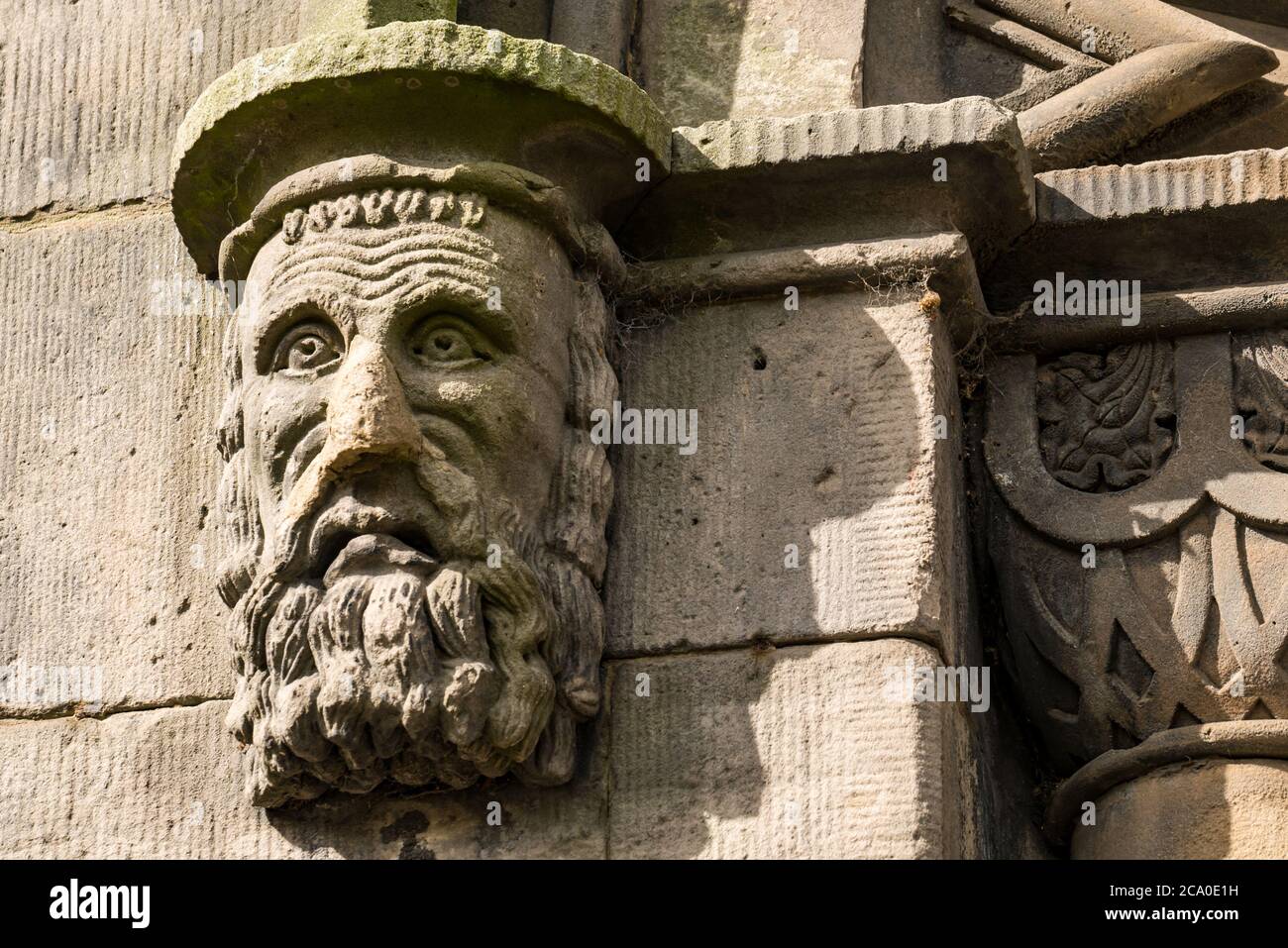 Worn corbel detail of  bearded face on St Thomas's Church built by John Henderson, now Guru Nanak Gurdwara Singh Sabha Sikh Temple, Leith, Edinburgh Stock Photo