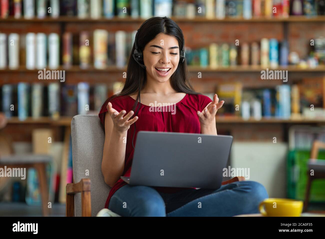 Online Tutoring. Young Asian Female Tutor Teaching Foreign Language Via Video Conference Stock Photo