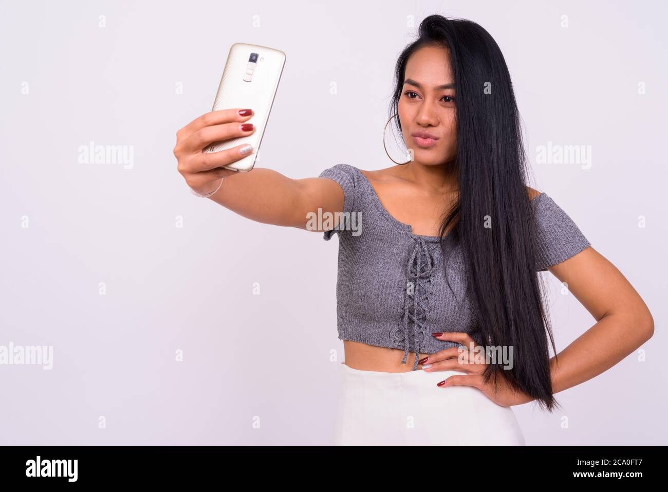 Portrait of young beautiful Asian woman taking selfie Stock Photo - Alamy