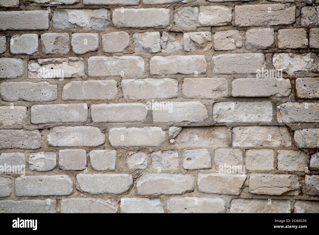 Real old brick wall crumbling from time to time Stock Photo