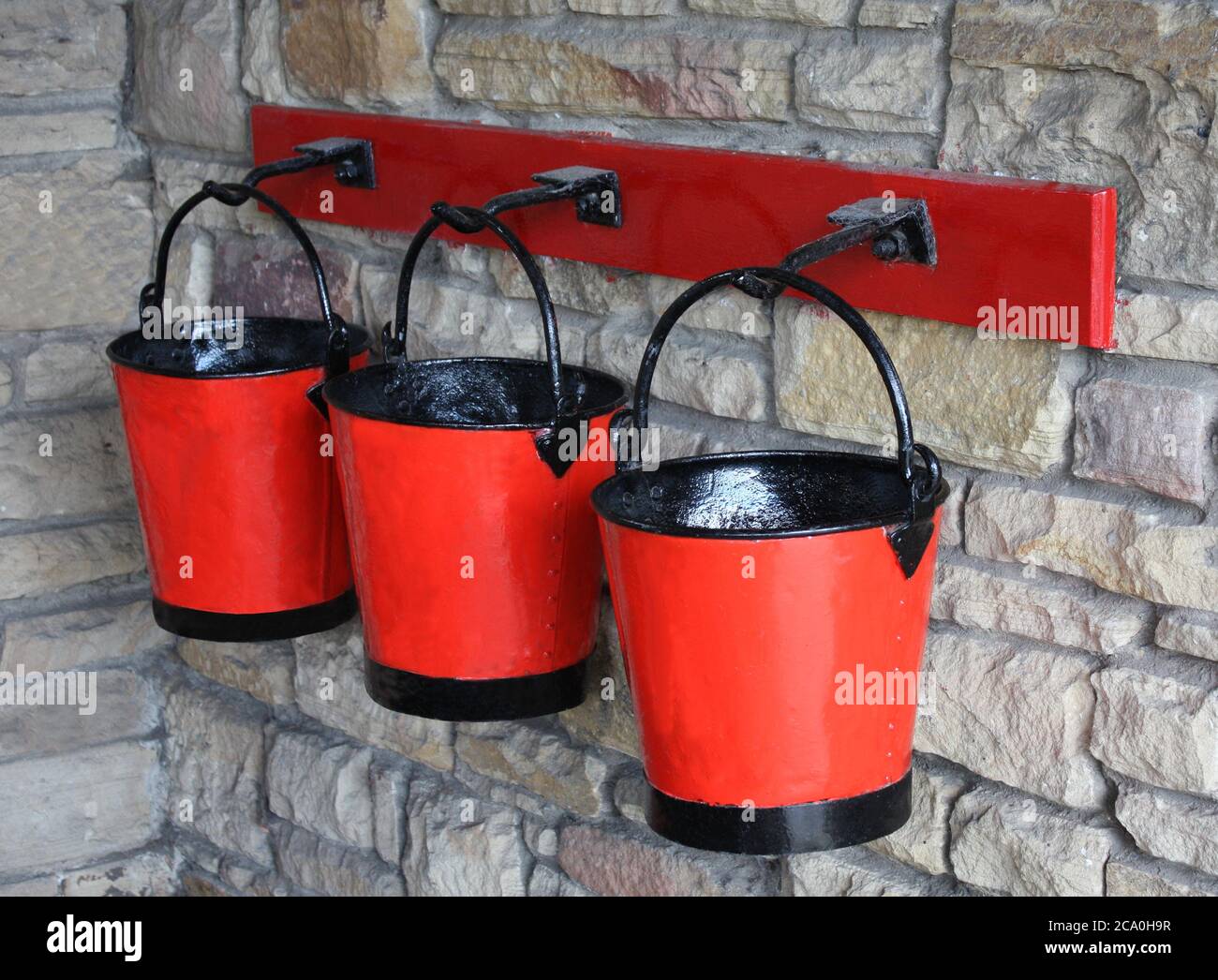 A Set of Three Red Vintage Fire Sand Buckets Stock Photo Alamy