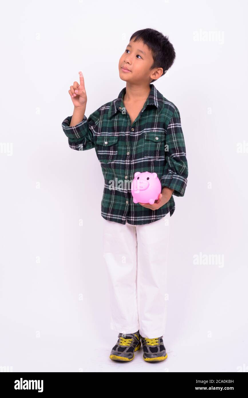 Portrait of cute Asian boy with piggy bank Stock Photo
