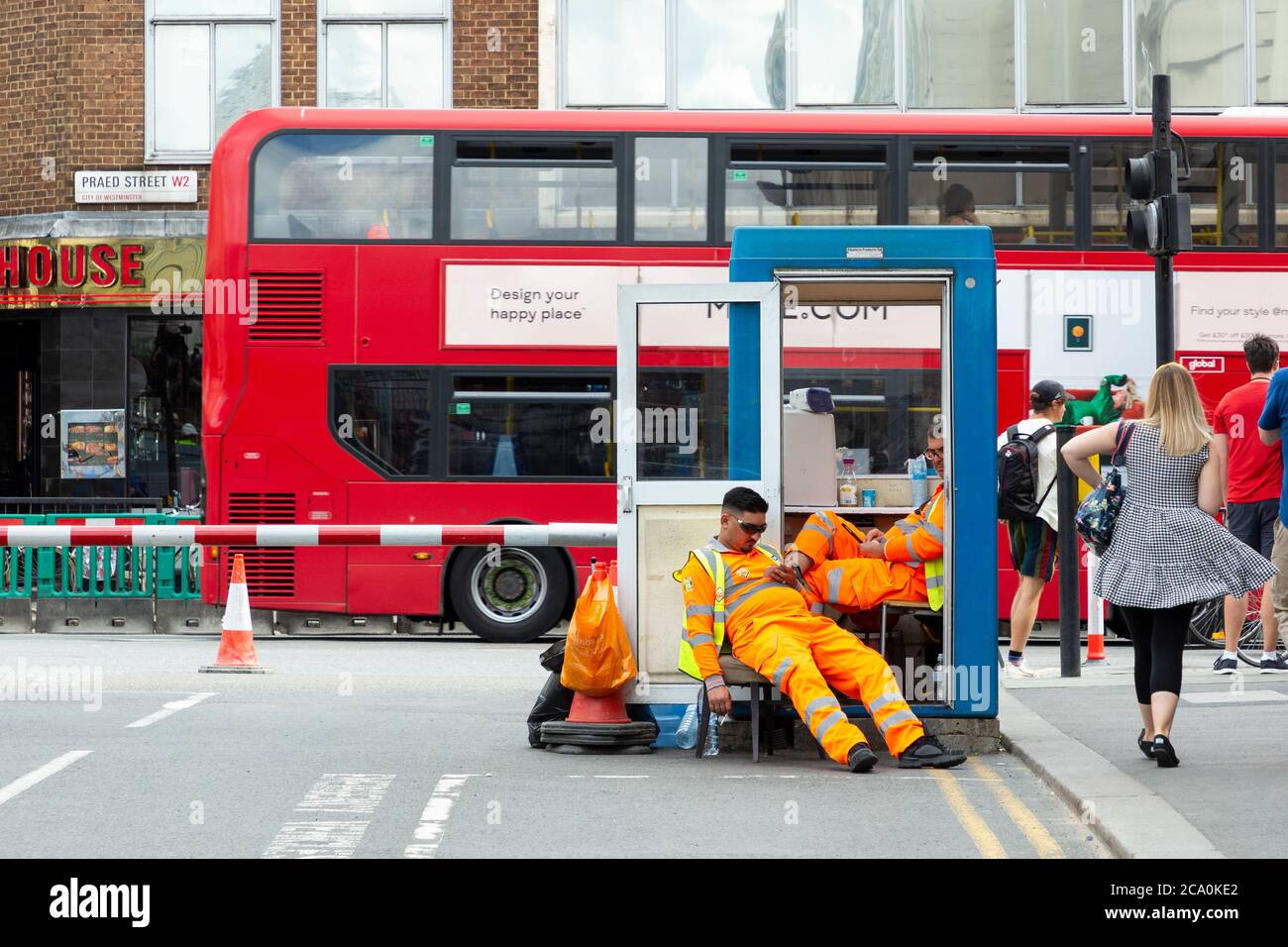 Parking wardens relaxing on Praed Street, Paddington, London Stock Photo